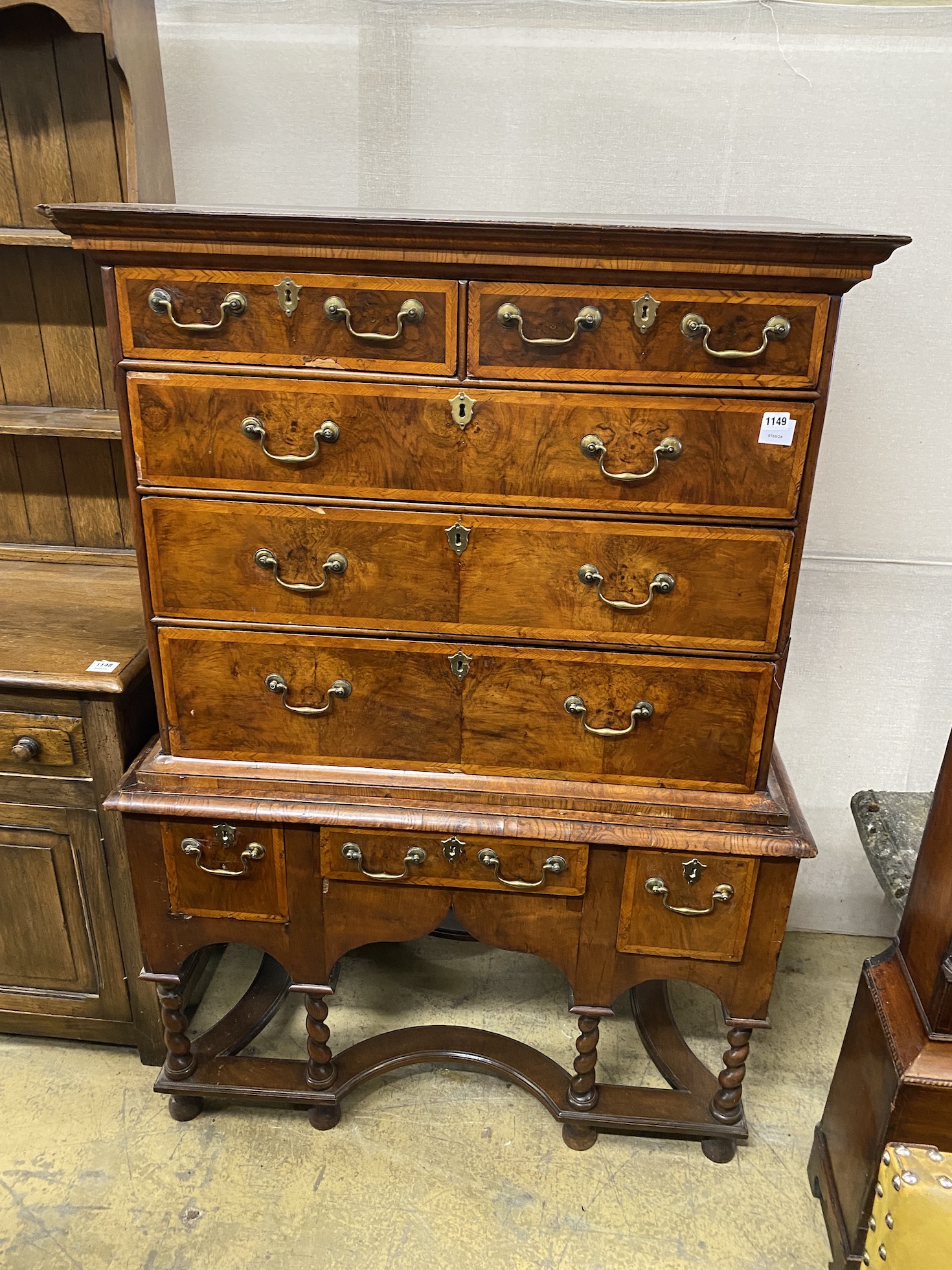 An early 18th century feather banded walnut chest on stand, width 106cm, depth 60cm, height 149cm